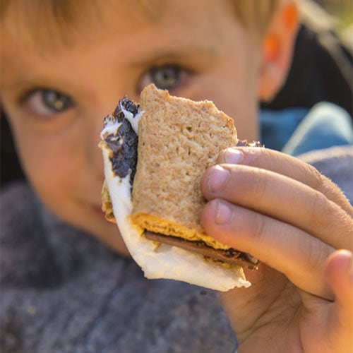 Child holding up s'mores
