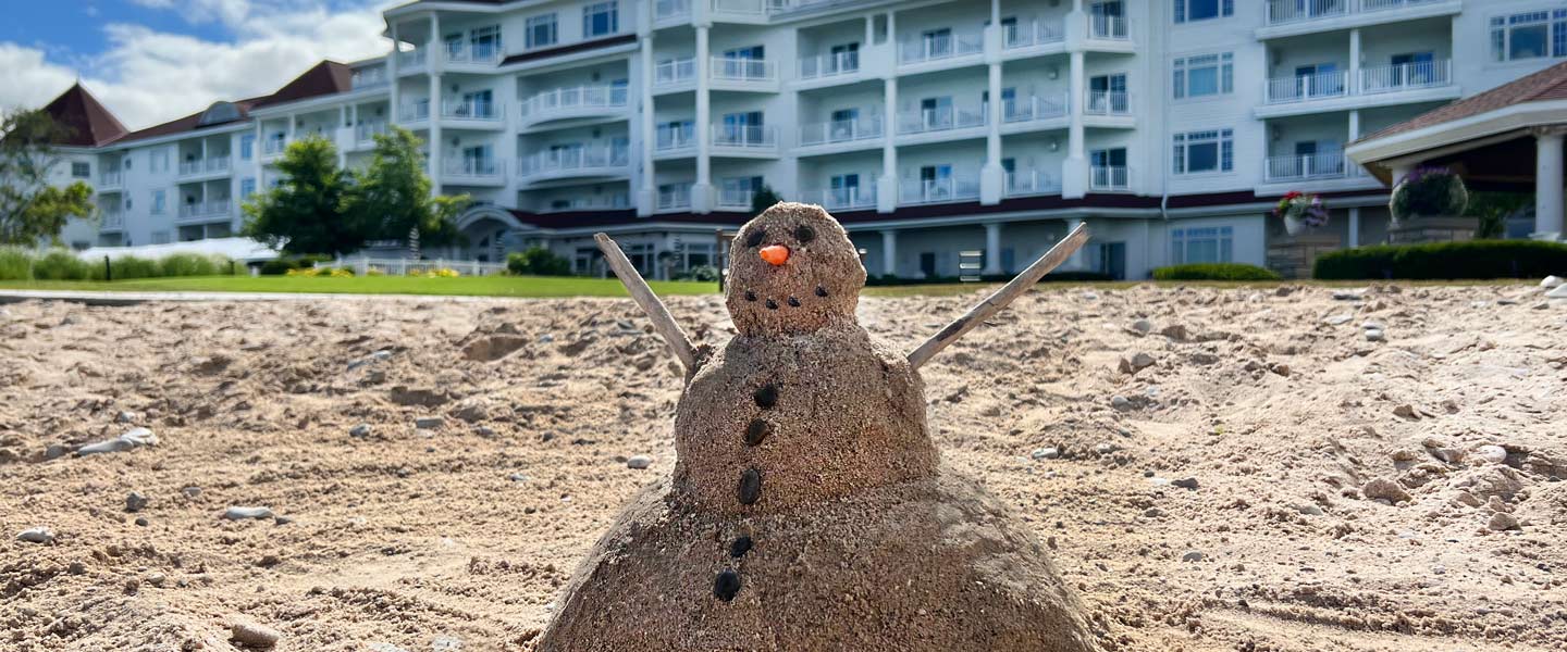 Snowman in sand at Inn at Bay Harbor